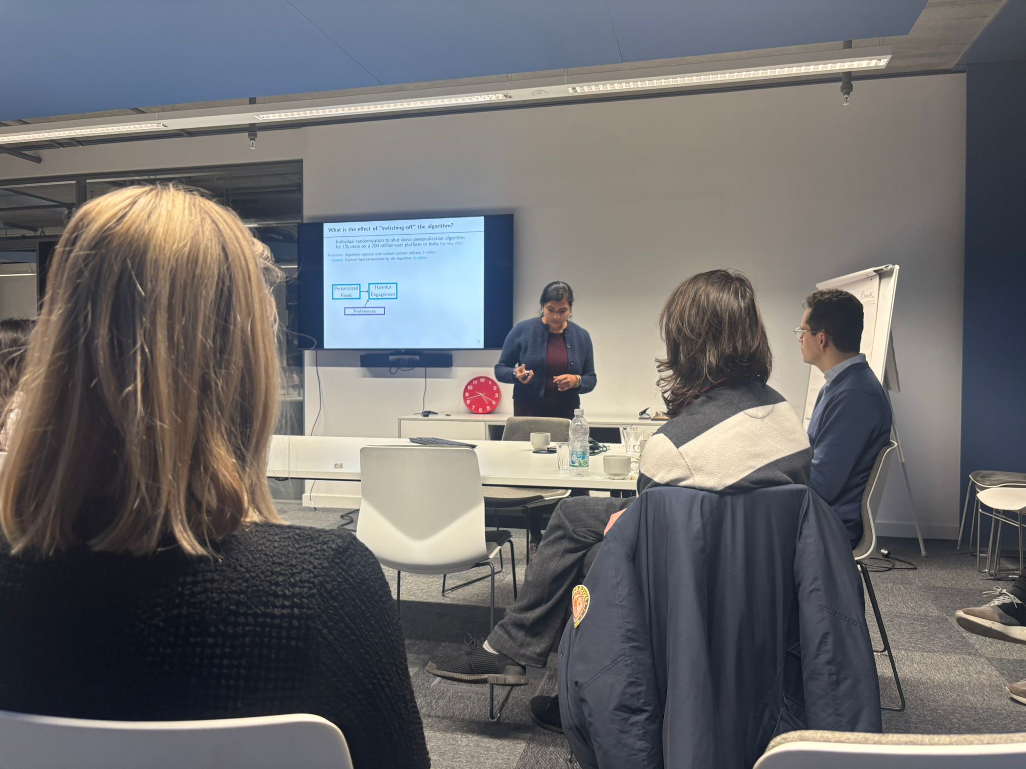 Speaker presenting research at the first edition
